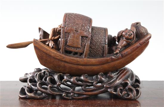 A Chinese bamboo model of a junk boat, with a stand carved as waves, late 19th/early 20th century, length 30cm